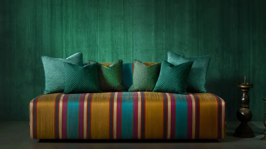 Groene wand met gestreepte bank. Stoffen van Jim Thompson.